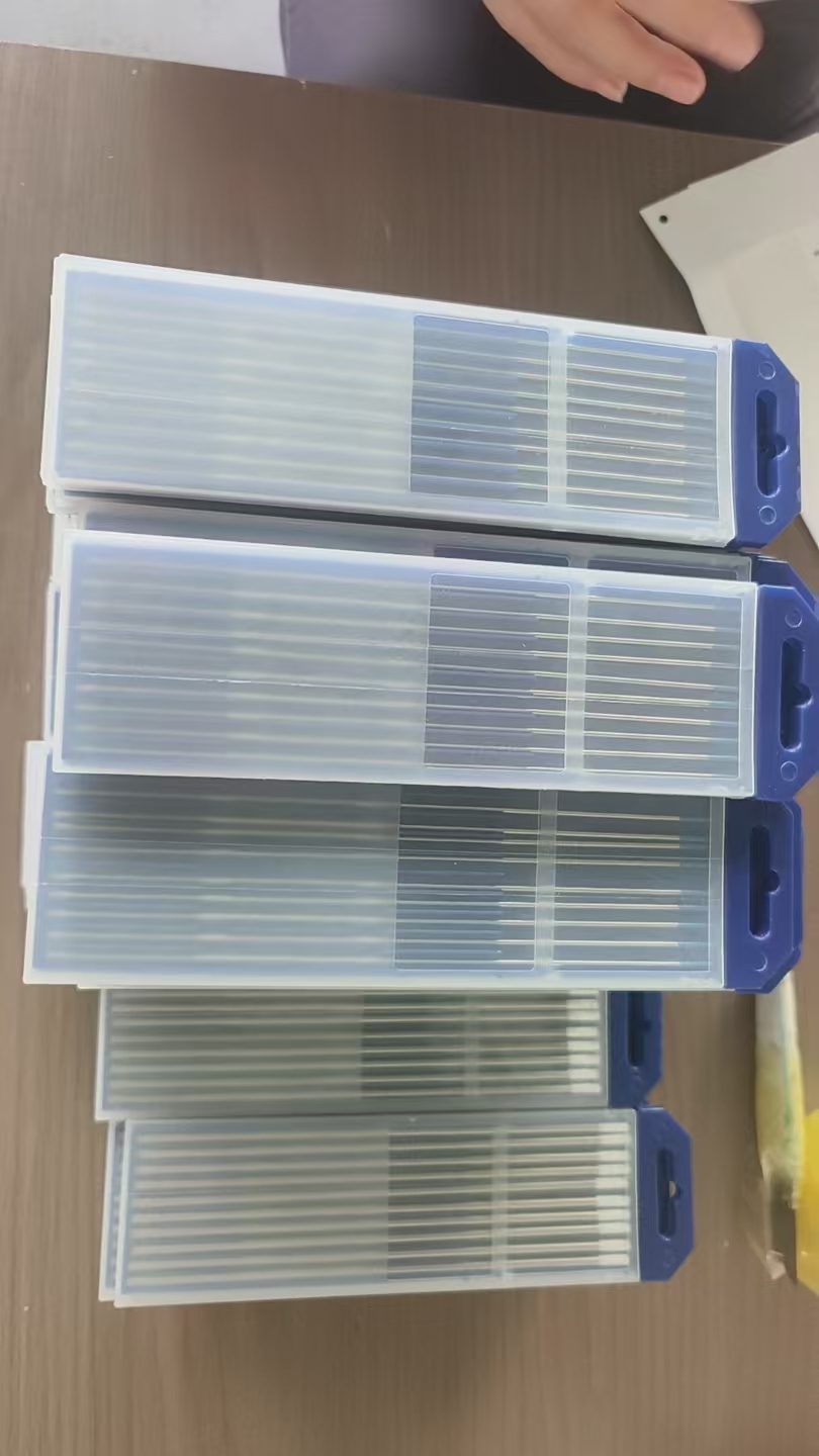 Stacks of plastic tube boxes with 10 tungsten electrodes each in the packing room