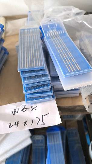 Warehouse shelf with blue tube boxes of WZ8 2.4 x 175 mm tungsten electrodes